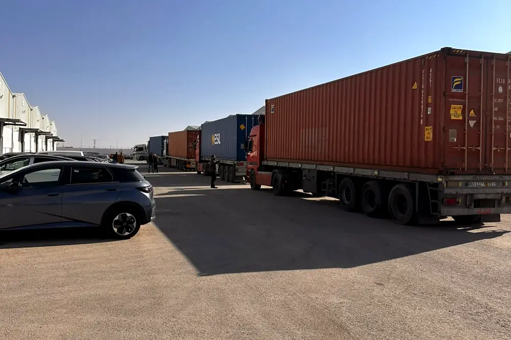 Container trucks delivering cargo to a warehouse in Jordan